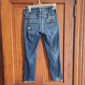 Blue Skinny Jeans with Distressed Hem and Fading